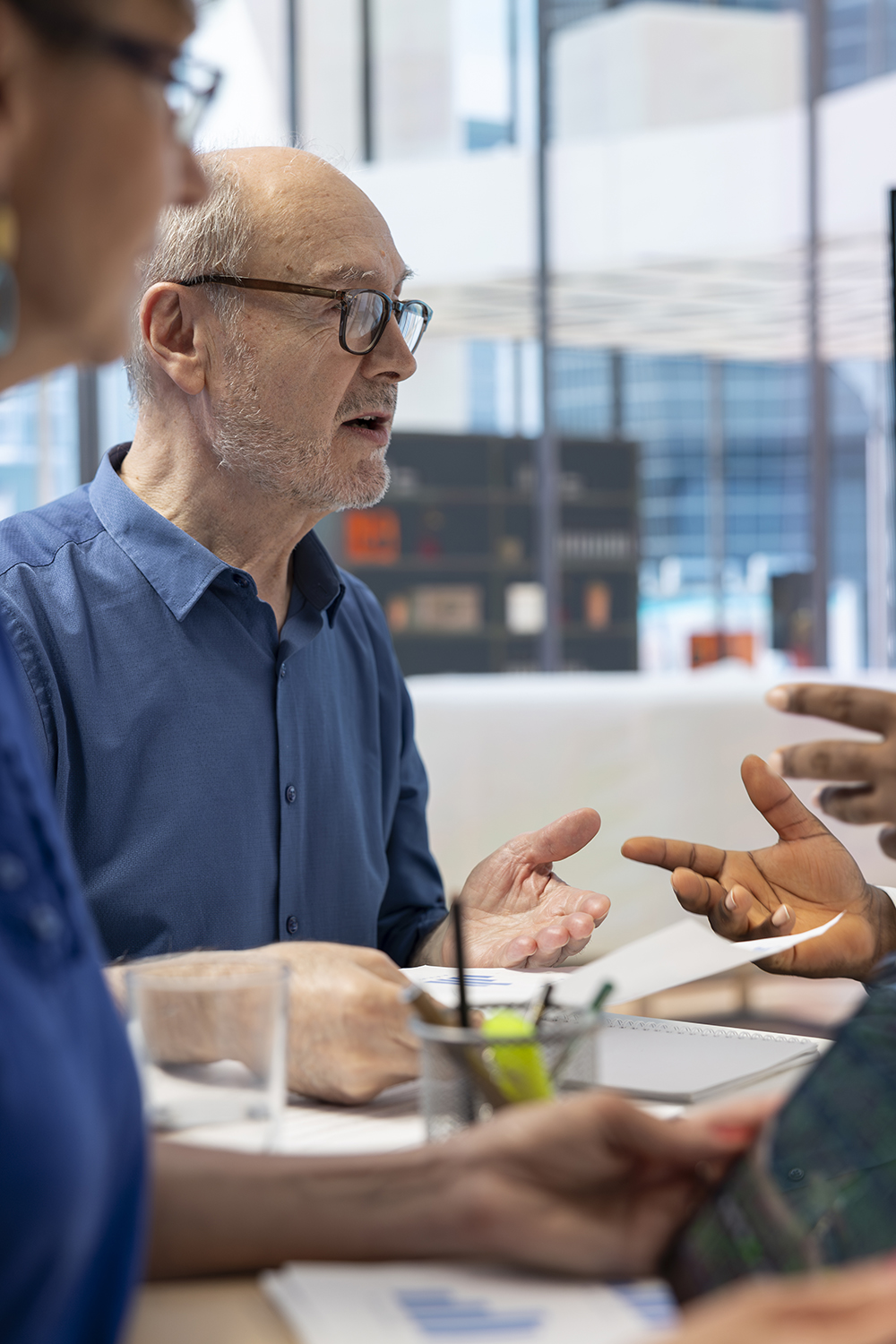 Mature couple meeting with financial expert to develop detailed retirement plan